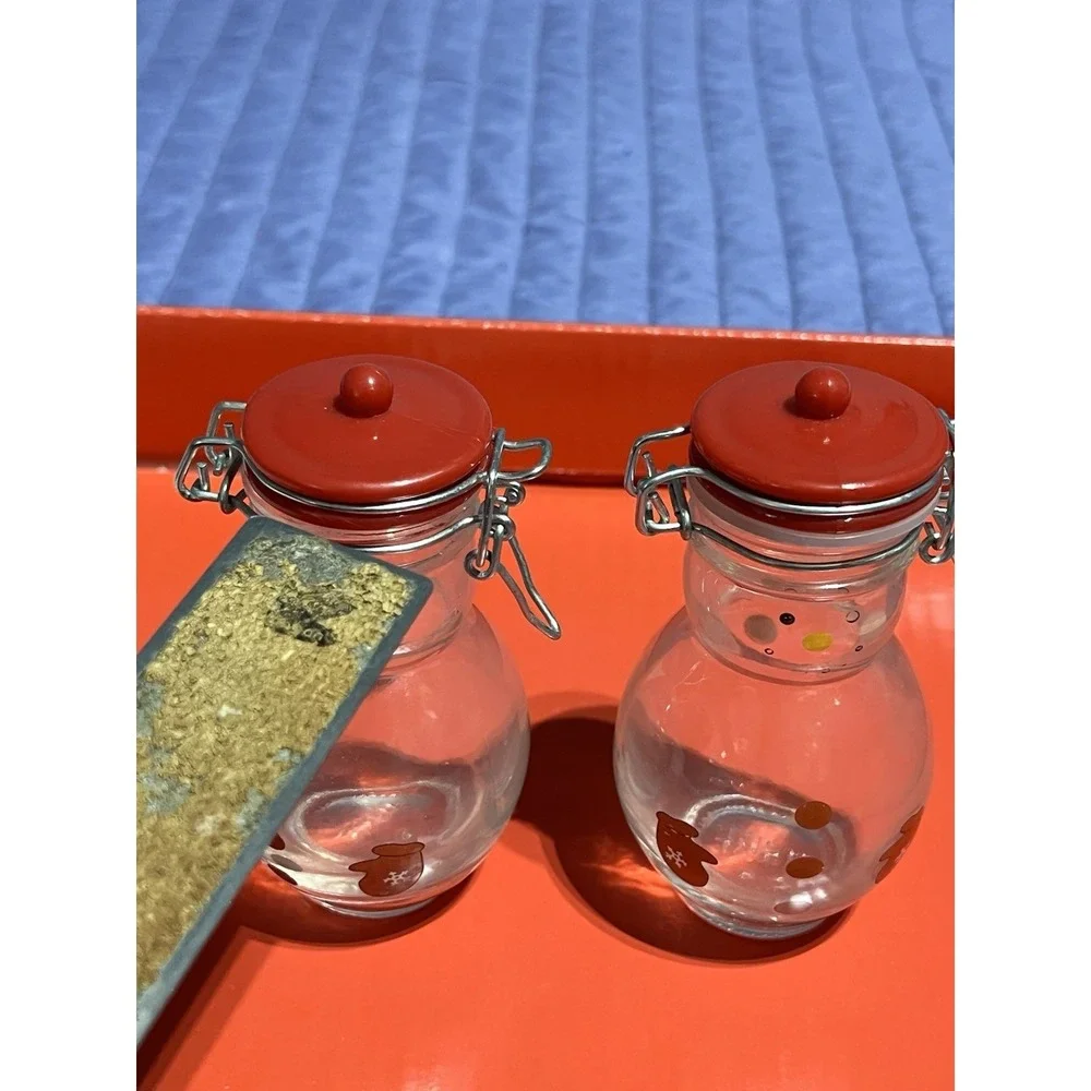 Set of 2 Snowman Glass Canisters with Red Lids. One Missing The Plastic Joint